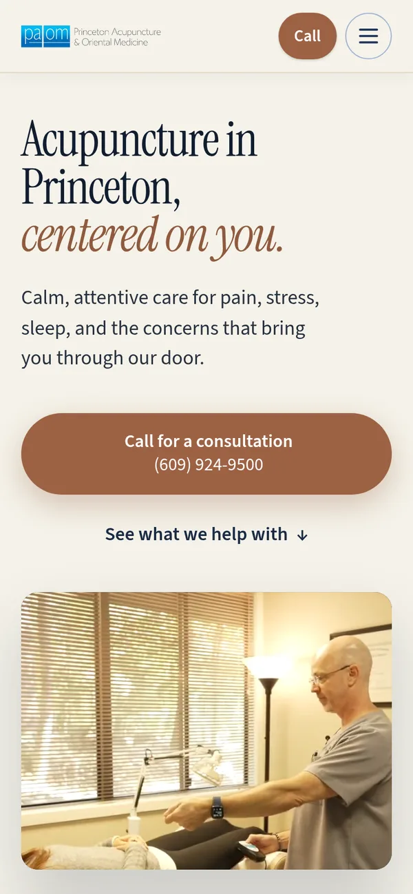 The same rebuilt homepage on a phone, with the call button above the fold